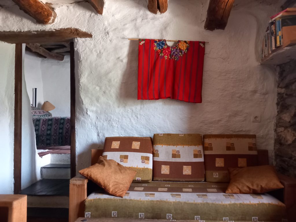 Sofa in sitting room looking through to bedroom in Walnut Cortijo.